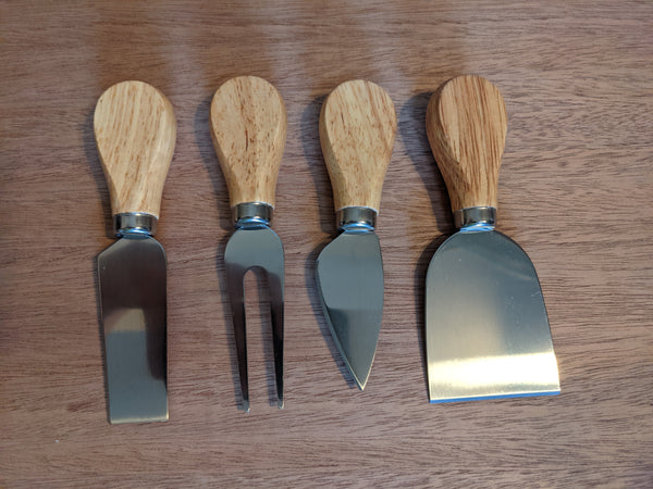 Set of four cheese tools with beautiful beechwood handles.