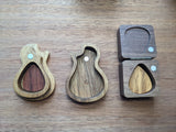 Small guitar shaped and square pick boxes open with picks inside